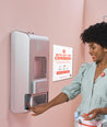 Person pushing button on Aunt Flow dispenser